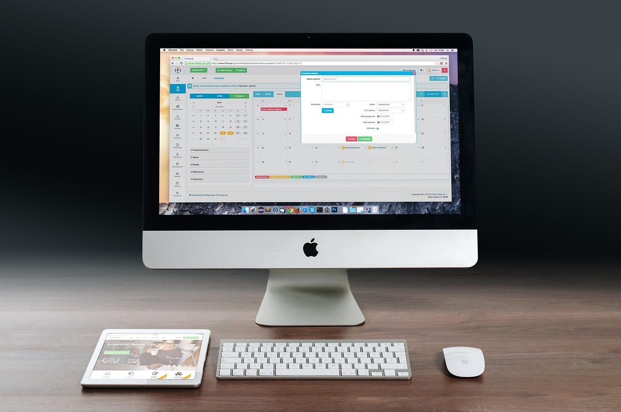 A clean and modern workstation with an iMac, iPad, and keyboard, representing creative design.