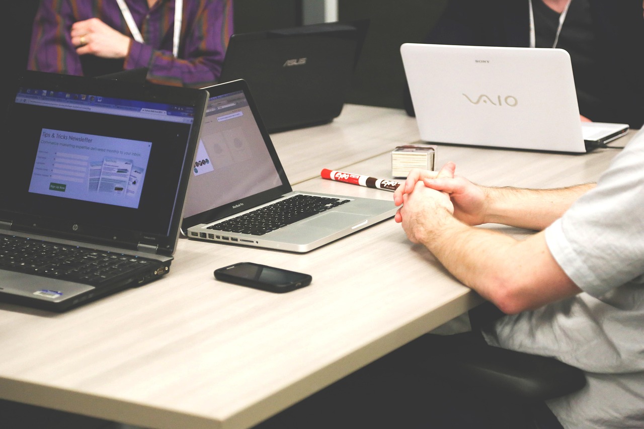 Team meeting around a table with laptops