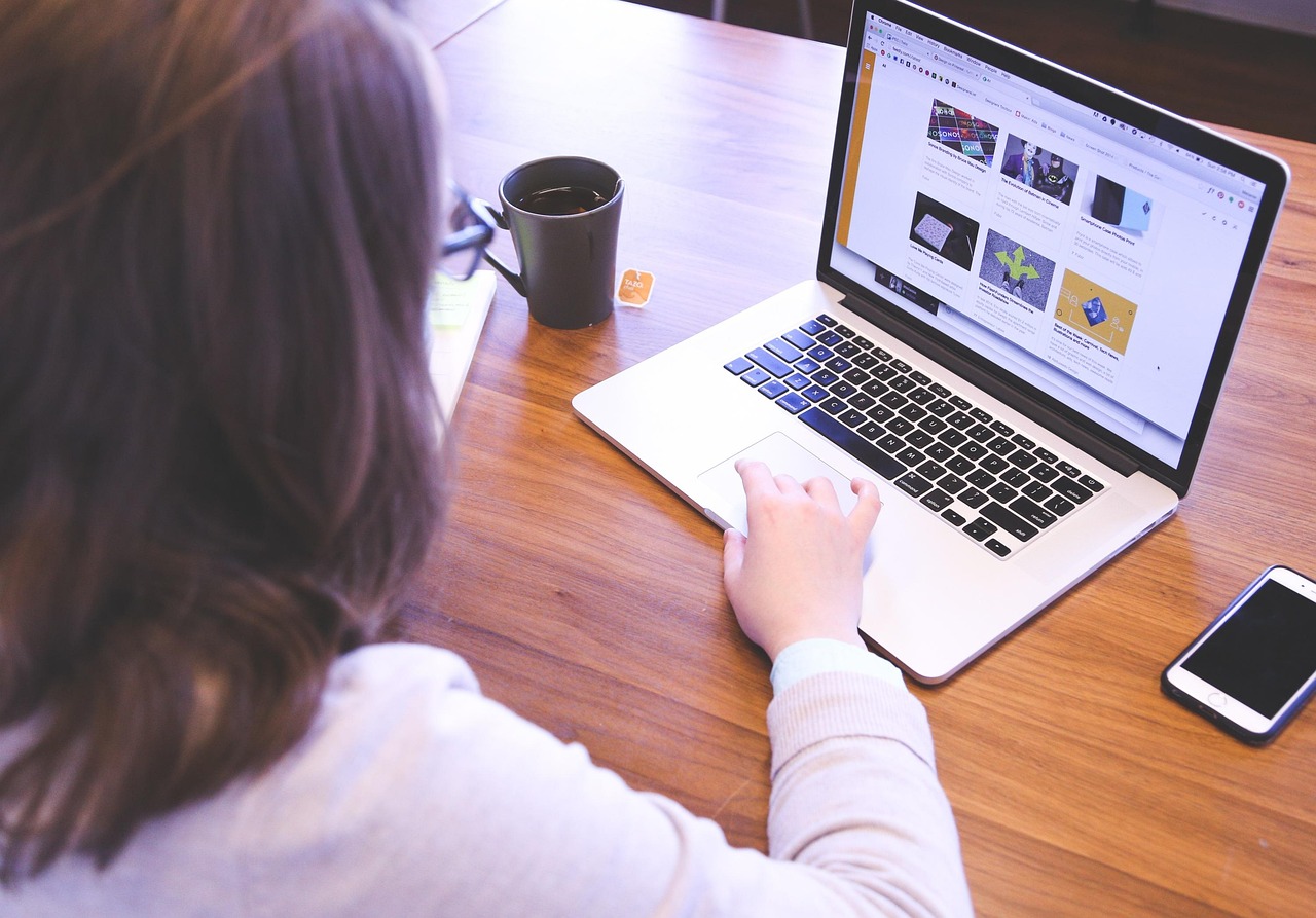 Young professional working on a laptop, displaying data visualizations